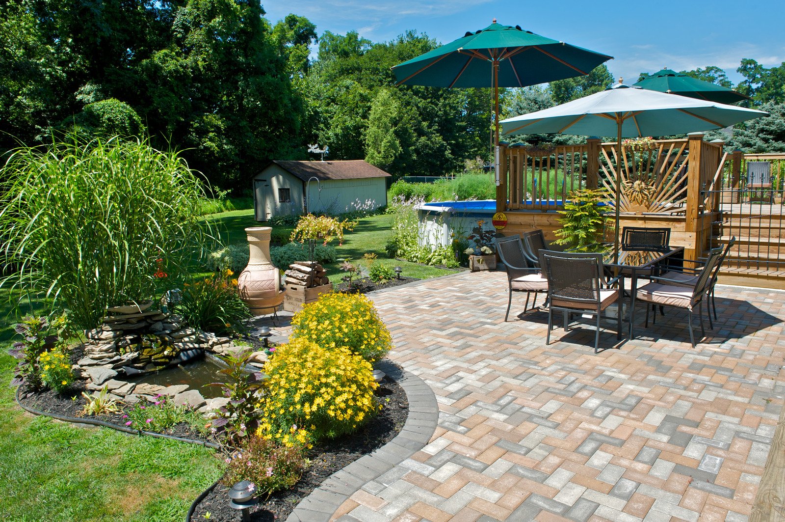 Paver patio with water feature and garden